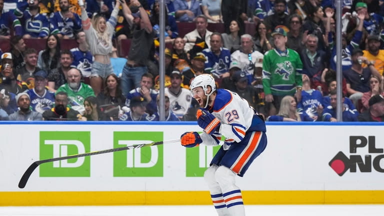 Edmonton Oilers' Leon Draisaitl celebrates Evan Bouchard's overtime goal against...