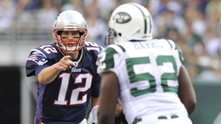 Patriots quarterback Tom Brady points at Jets linebacker David Harris...