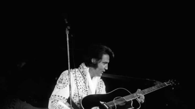Elvis Presley on stage performing at the Nassau Veterans Memorial...