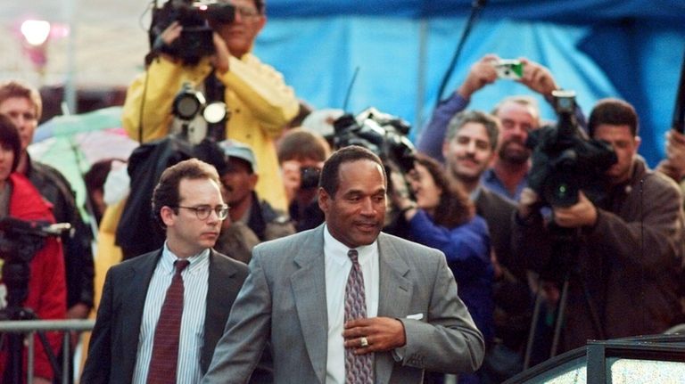 O.J. Simpson and his defense attorney Daniel Leonard leave Los...