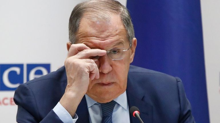 Russia's Foreign Minister Sergey Lavrov adjusts the glasses during his...