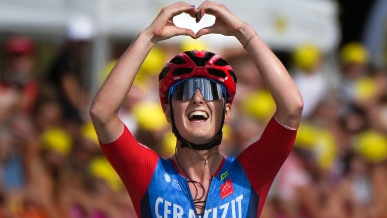 Cedrine Kerboal of France forms a heart as she crosses...