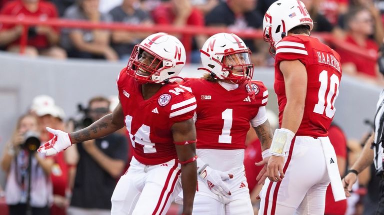 Nebraska's Billy Kemp IV (1) celebrates a touchdown with teammates...