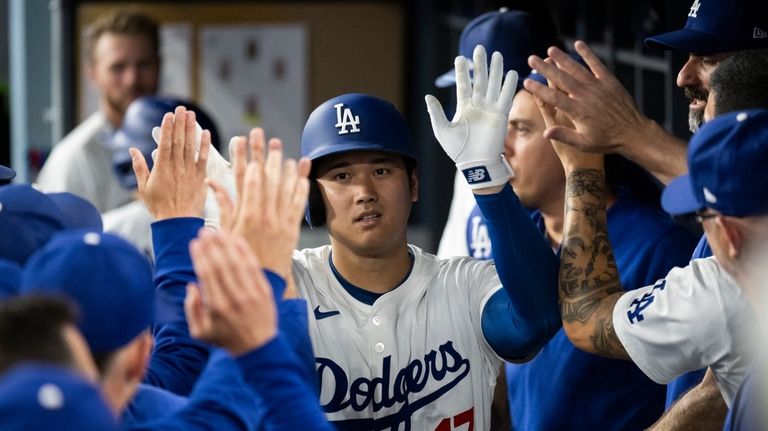 Los Angeles Dodgers' Shohei Ohtani celebrates his solo home run...