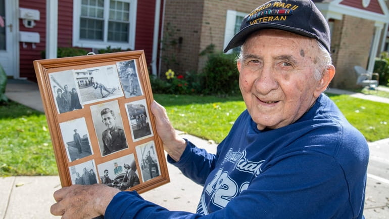 Ed Peyser, 99, of Greenlawn holds some of his World...