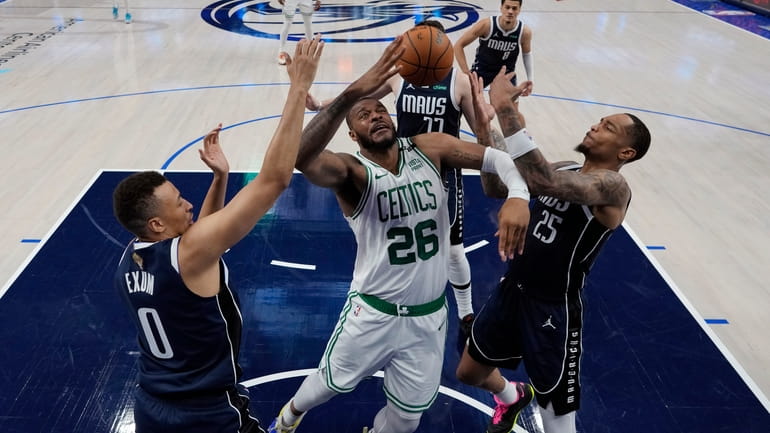 Boston Celtics forward Xavier Tillman (26) battles Dallas Mavericks guard...