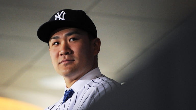 Masahiro Tanaka of the Yankees looks on during his introductory press...