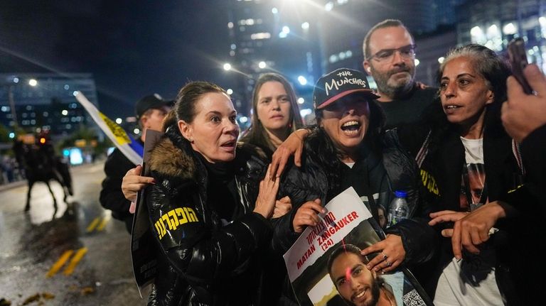 Former hostage Ilana Grisewsky, center, takes part in a protest...