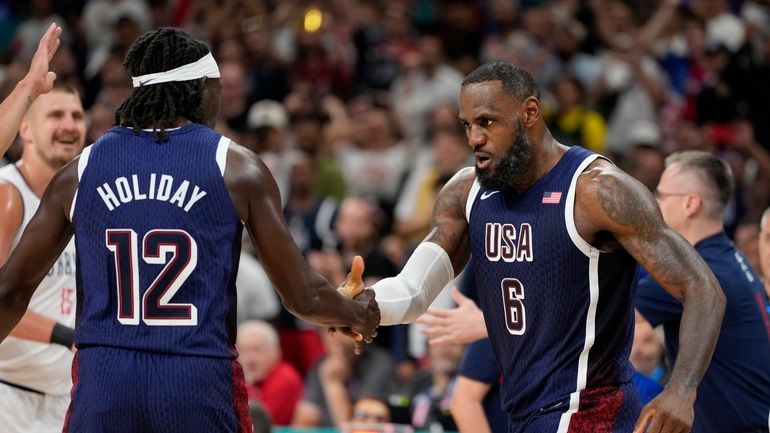 LeBron James, right, of the United States, celebrates with Jrue...