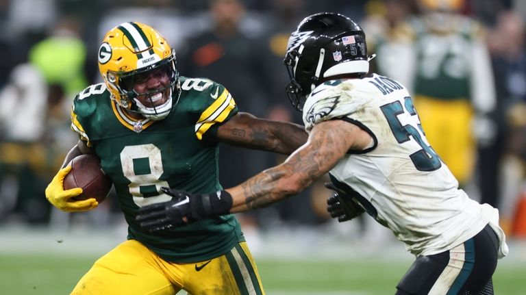 Green Bay Packers running back Josh Jacobs (8) runs past...