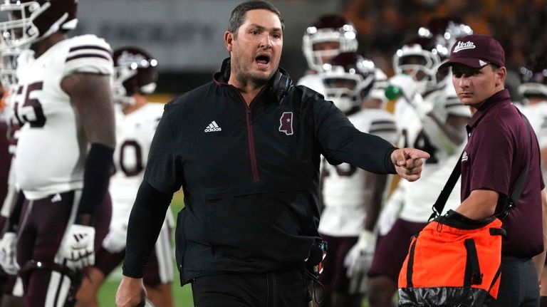 Mississippi State head coach Jeff Lebby, center, reacts after a...