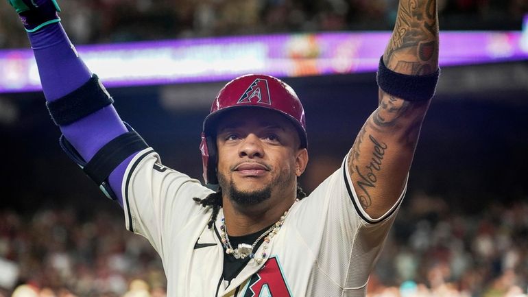 Arizona Diamondbacks' Ketel Marte acknowledges fans as he celebrates after...