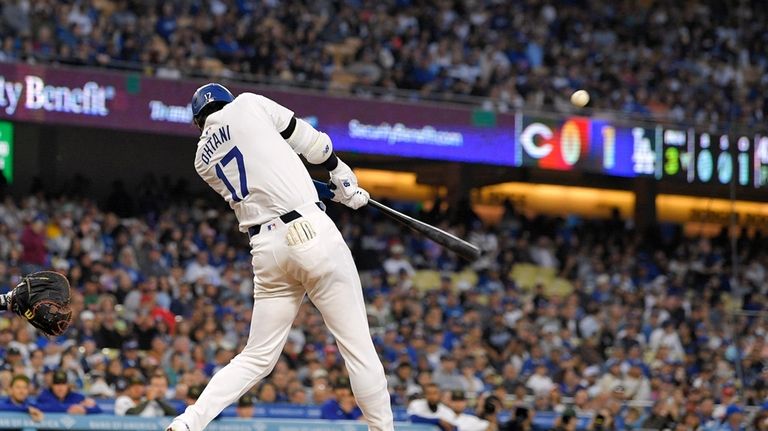 Los Angeles Dodgers designated hitter Shohei Ohtani hits a two-run...