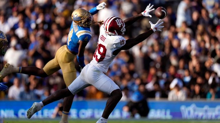 Indiana wide receiver Miles Cross, right, makes a catch as...