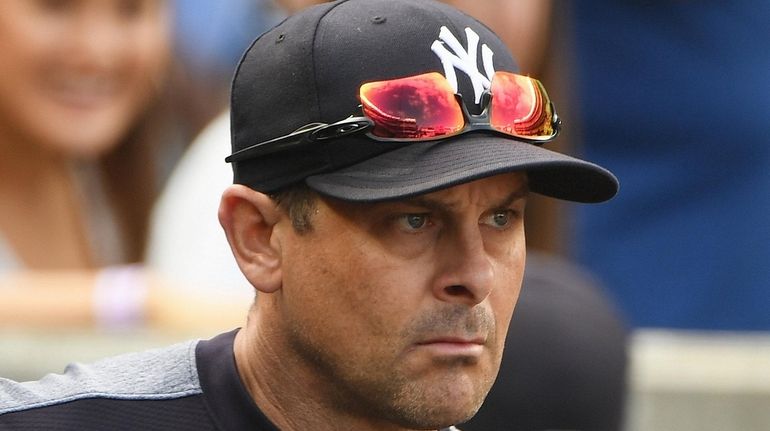 New York Yankees manager Aaron Boone looks on from the...