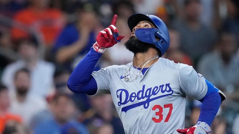 Los Angeles Dodgers' Teoscar Hernández runs the bases after hitting...