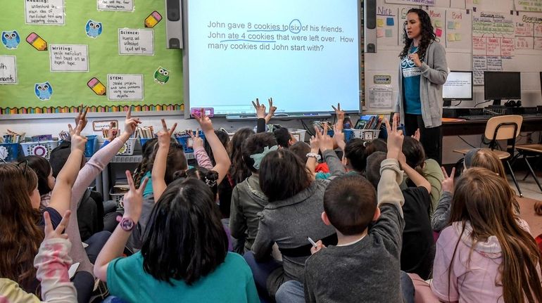 In the Longwood school district Wednesday, teacher Lisa Zacpal instructs third-graders at...