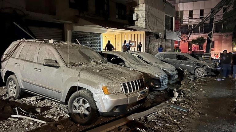 People inspect damaged cars in the southern suburbs of Beirut,...