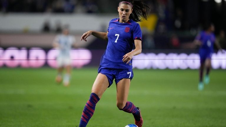 U.S. forward Alex Morgan controls the ball during the first...