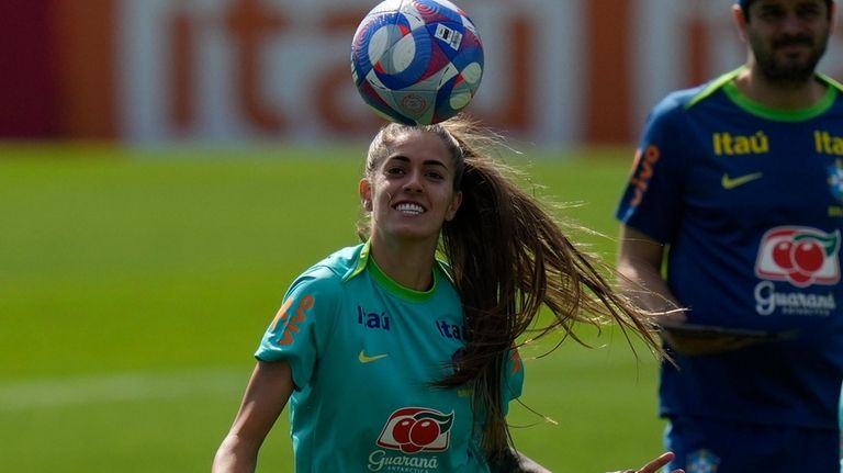 Brazilian soccer player Jhennifer controls the ball during a practice...