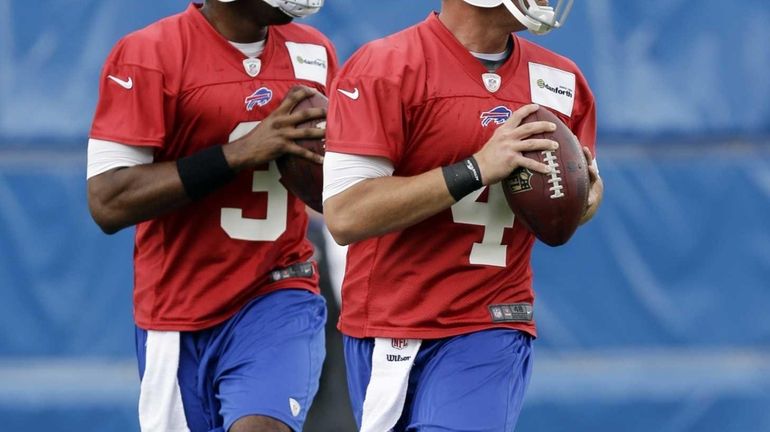 Buffalo Bills quarterbacks Kevin Kolb, right, and EJ Manuel run...