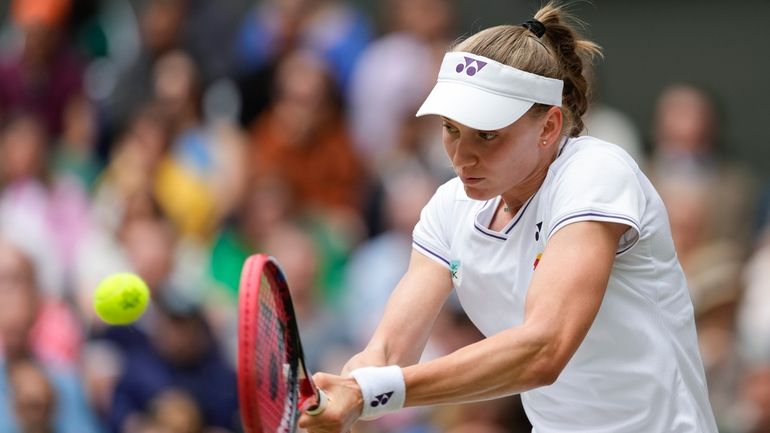 Elena Rybakina of Kazakhstan plays a backhand return to Elina...