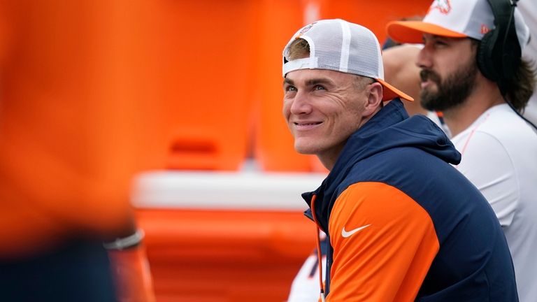 Denver Broncos quarterback Bo Nix smiles as he sits on...