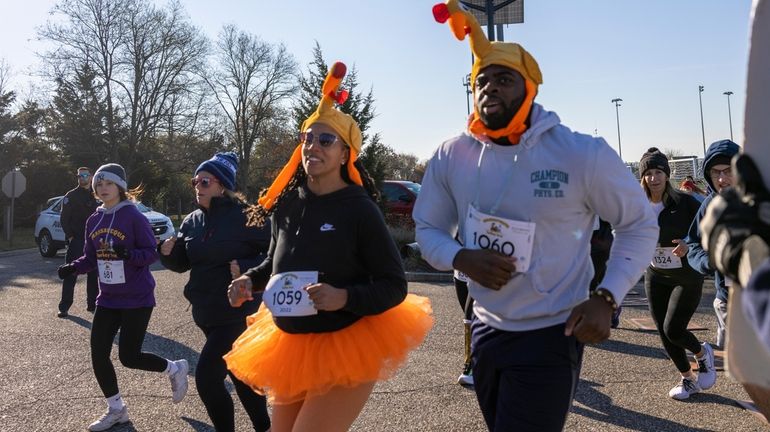 Aaron Howard and Sophia Pierre-Gatke run in the Massapequa Thanksgiving...