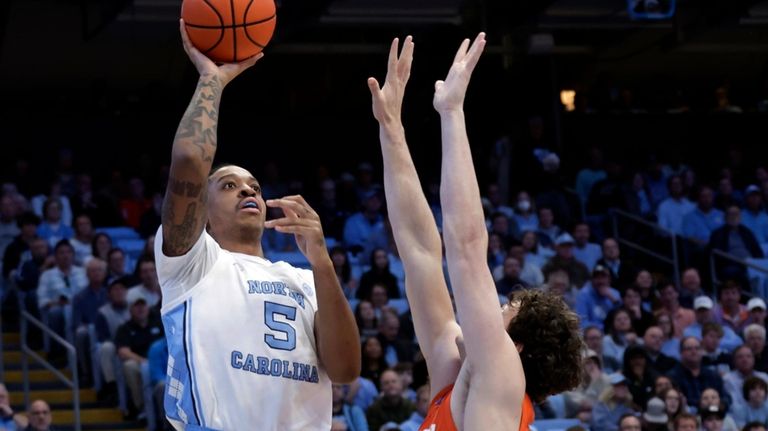 North Carolina forward Armando Bacot (5) shoots over Clemson center...