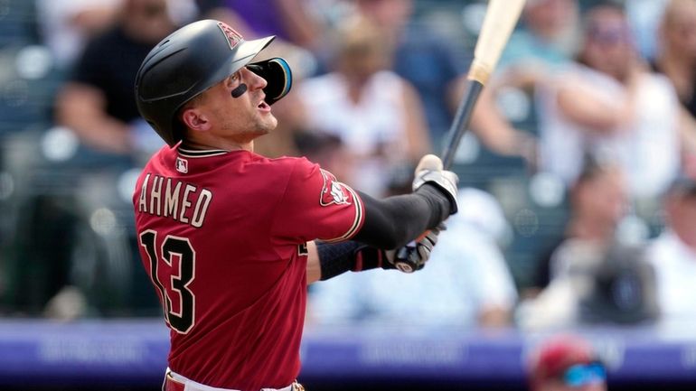 Arizona Diamondbacks' Nick Ahmed follows the flight of his triple...