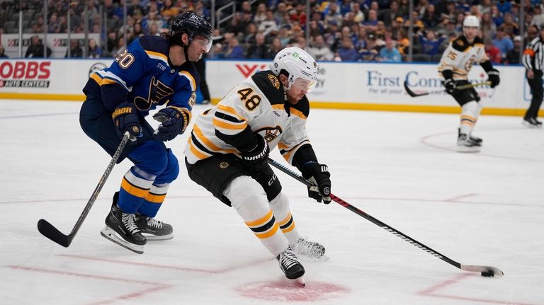 Boston Bruins' Matt Grzelcyk (48) controls the puck as St....