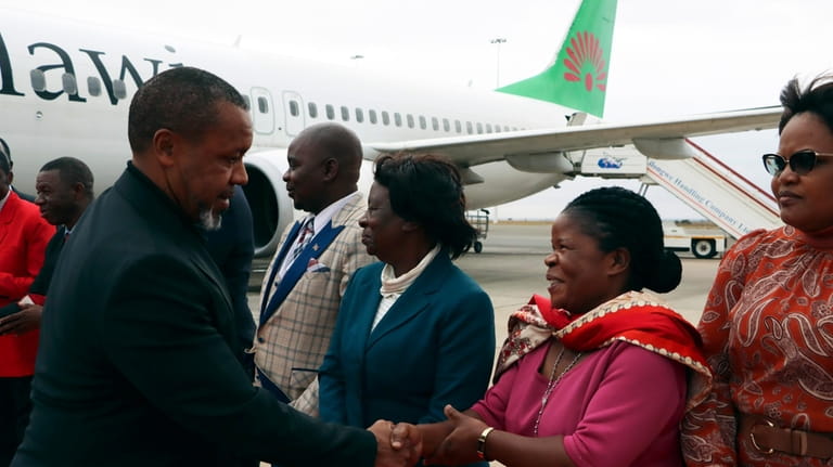 Malawi Vice President Saulos Chilima, left, greets government officials upon...