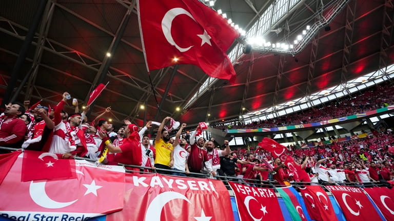 Turkey fans cheer before a round of sixteen match between...