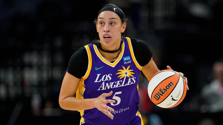 Los Angeles Sparks forward Dearica Hamby dribbles down the court...