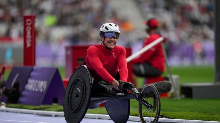 Switzerland's Catherine Debrunner celebrates after winning the women's 1500 m....