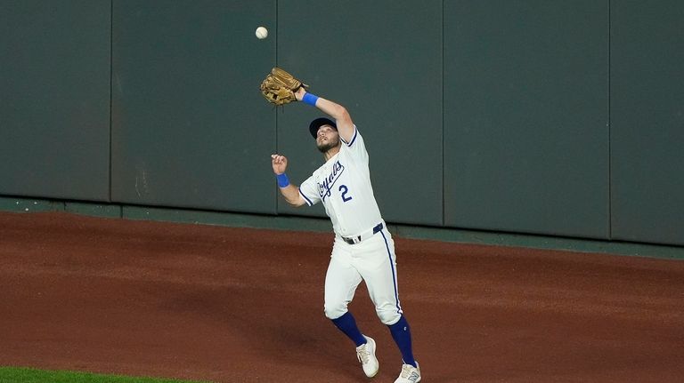 Kansas City Royals center fielder Garrett Hampson catches a fly...