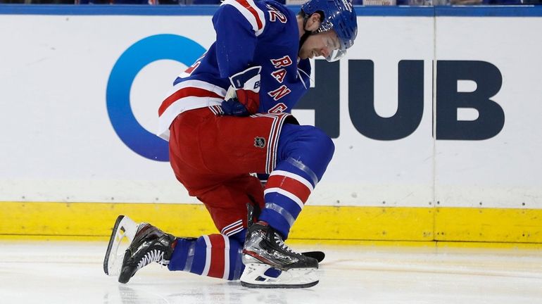 Filip Chytil #72 of the New York Rangers grimaces after...