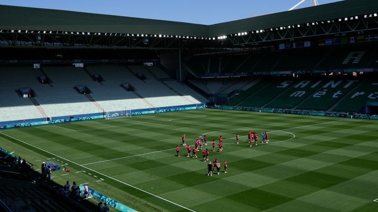 Canada's players walk on the pitch ahead of their soccer...