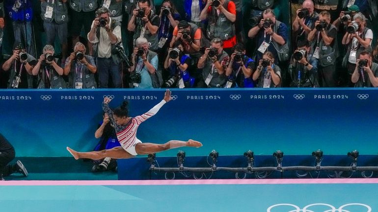 Simone Biles, of United States, performs on the beam during...