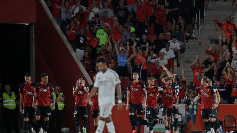 Real Madrid's Rodrygo walks back as Mallorca players celebrate after...