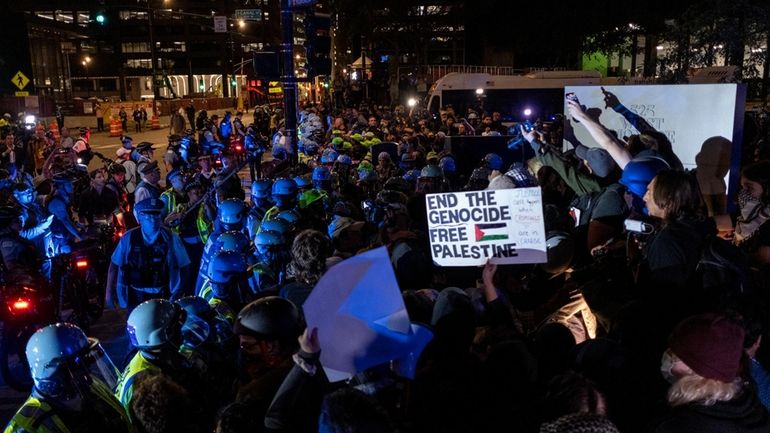 Police surround a group of pro-Palestinian protesters near the Israeli...