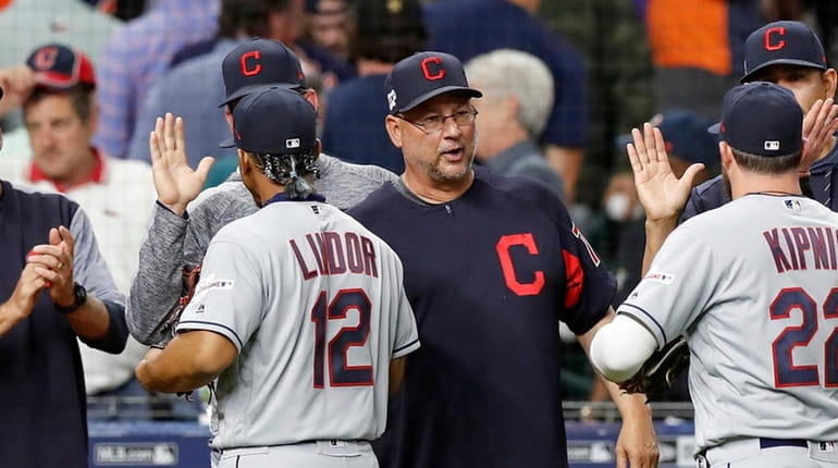 Terry Francona #77 of Cleveland congratulates players after the game...