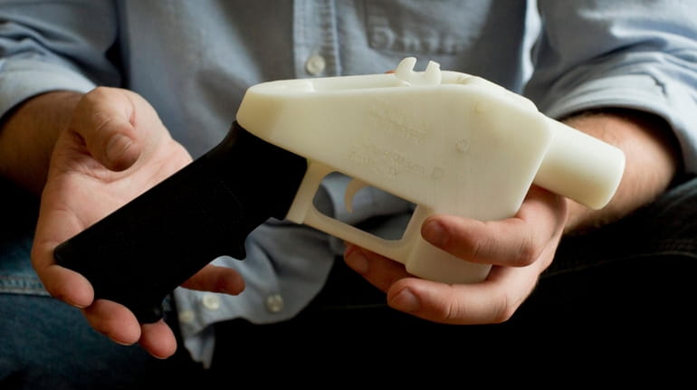 Cody Wilson holds what he calls a Liberator pistol that was...