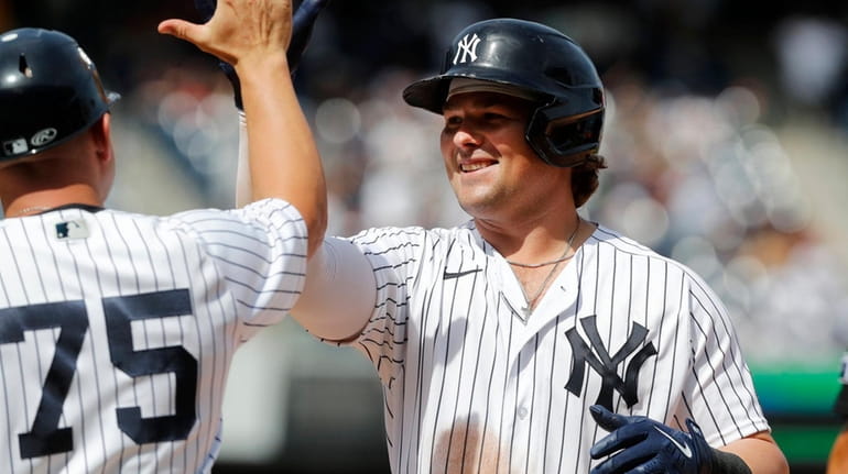 Luke Voit of the Yankees celebrates his fifth-inning two-run single...
