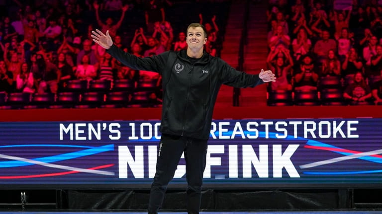 Nic Fink reacts after winning the men's 100 breaststroke finals...