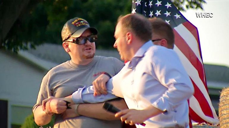 David Jakubonis, left, accosts Rep. Lee Zeldin, right, the Republican candidate...