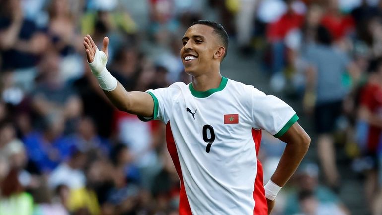 Morocco's Soufiane Rahimi celebrates after scoring his side's fourth goal...