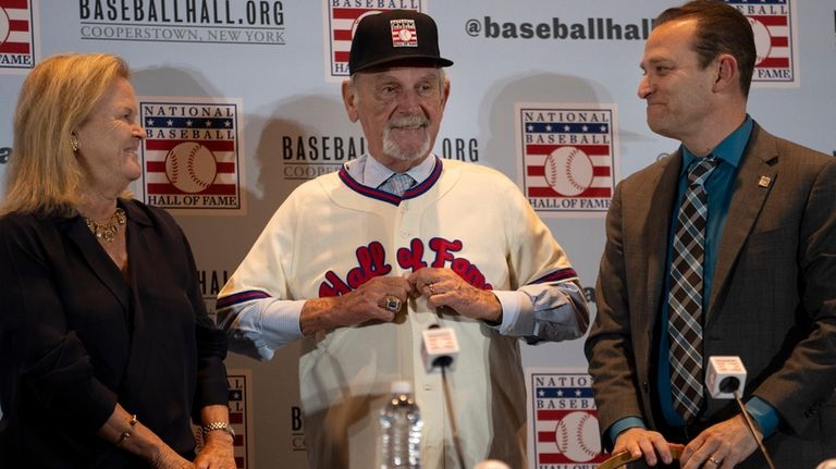 Former baseball manager Jim Leyland, center, puts on a Hall...