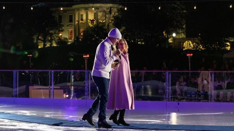 1988 Olympic figure skater Brian Boitano, left, skates next to...