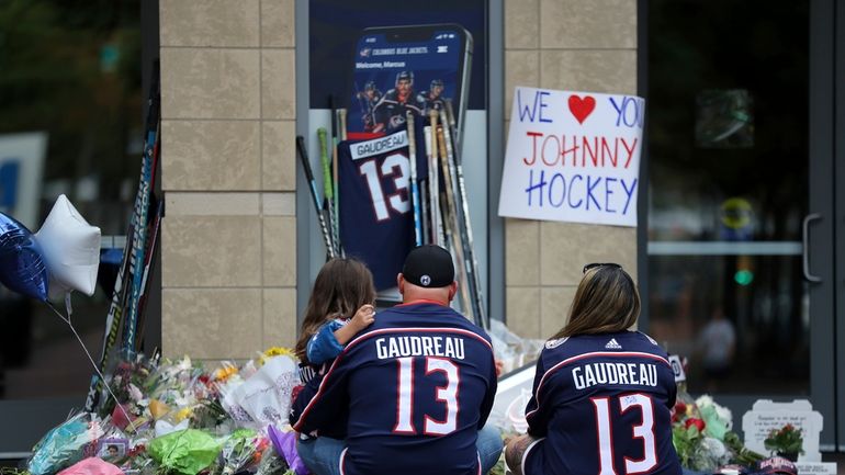 Shiloh Rivera, left, mourns with Hylas Stemen, center, and Amanda...